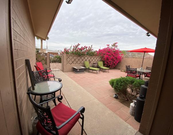 Outdoor patio with chairs and flowering plants