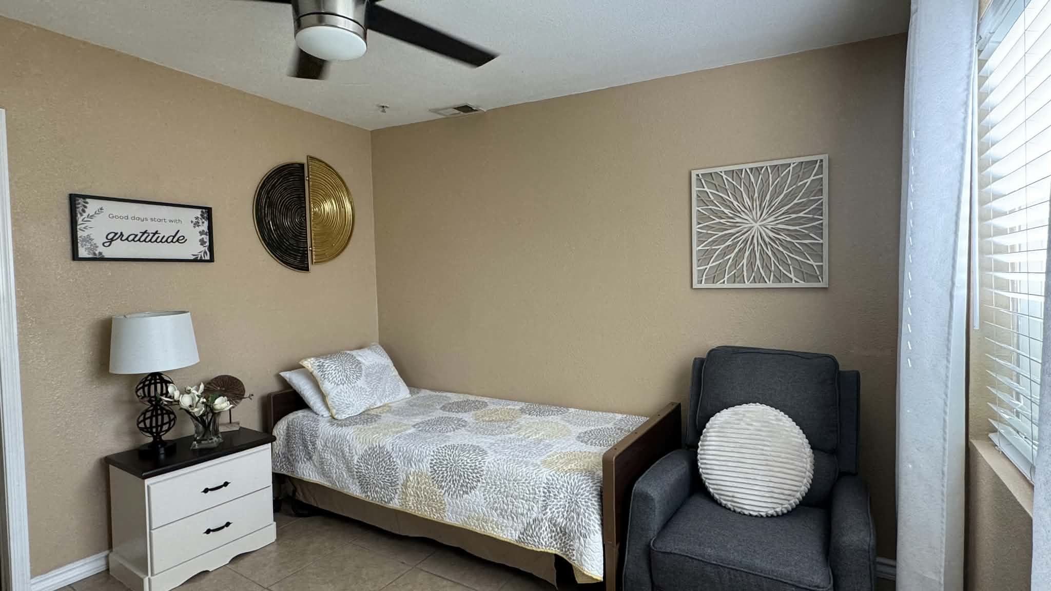 Bedroom with a wooden bed, bedside lamp and upholstered armchair